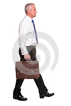 Mature businesman walking, side view.