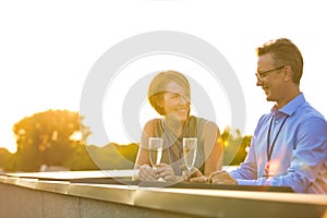 Mature business colleagues talking at rooftop during success party