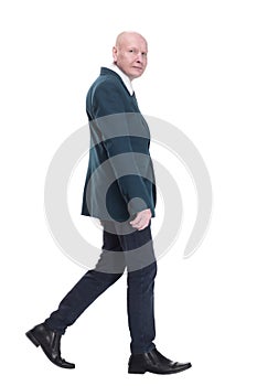 Mature business man striding forward. isolated on a white background.