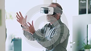 Mature business man wearing virtual reality googles / VR Glasses