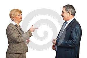 Mature business woman point to her colleague man