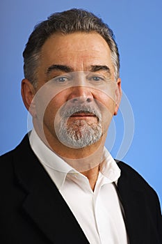 Mature businessman against blue background