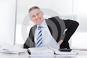 Mature businessman with back pain
