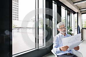 Mature businessman in blue shirt in the office.