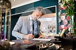 Mature businessman at hotel reception.