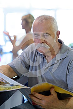 mature businessman with newspaper in cafe photo