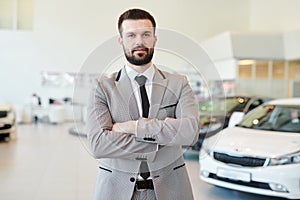 Mature Businessman Posing in Car Showroom