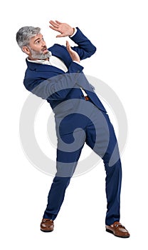 Mature businessman in stylish clothes avoiding something on white background