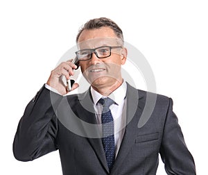 Mature businessman talking by mobile phone on white background