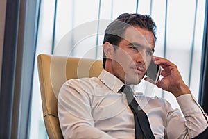 Mature businessman talking on smartphone