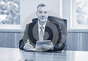 Mature Businessman using tablet computer