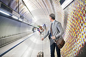 Mature businessman waiting on a metro station.