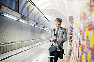 Mature businessman waiting on a metro station.