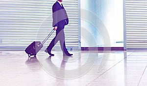 Mature businessman walking with his suitcase in the airport