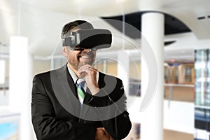 Mature Businessman wearing Virtual Reality Goggles