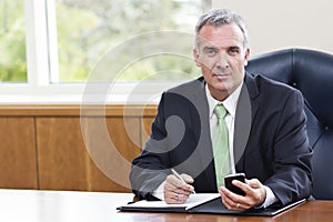 Mature Businessman working in his office photo