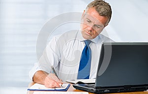 Mature businessman working in office