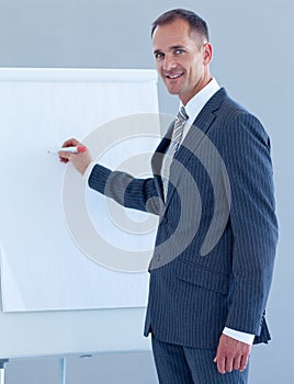 Mature businessman writing in a whiteboard