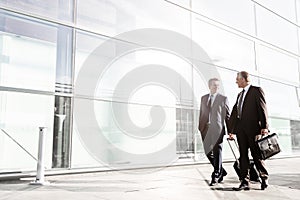 Mature businessmen walking while talking in the airport