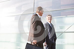 Mature businessmen walking while talking in the airport