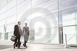 Mature businessmen walking while talking in the airport