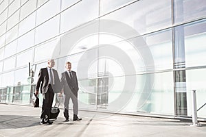 Mature businessmen walking while talking in the airport