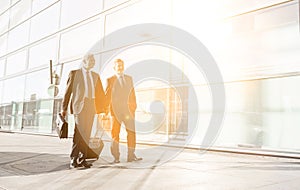 Mature businessmen walking while talking in the airport