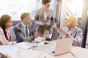 Mature businesswoman conducting a presentation in modern board room