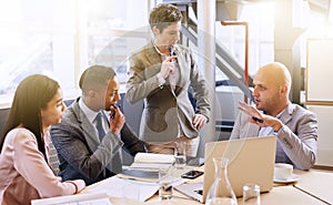 Mature businesswoman conducting a presentation in modern board room