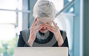 Mature, businesswoman and laptop or stress headache in office as teach ceo with pressure, sinus or pain. Female person