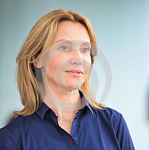 Mature businesswoman looking away against colleague at office