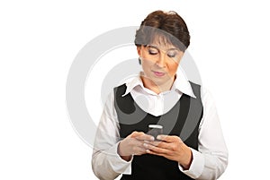 Mature businesswoman sending sms