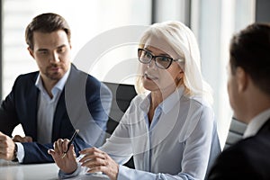 Mature businesswoman talk negotiating with business partners at meeting