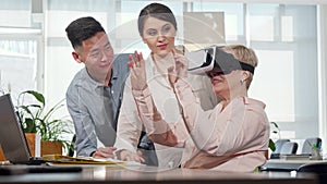 Mature businesswoman using 3d virtual reality goggles at work