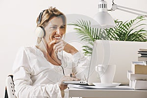 Mature businesswoman working with laptop at home.