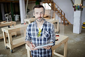 Mature Carpenter Posing in Workshop