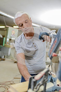 Mature carpenter working alone