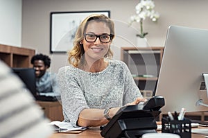 Mature casual woman working on computer