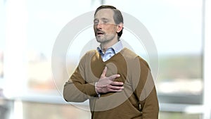 Mature caucasian man having heart pain.