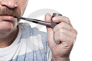 Mature caucasian man holding smoking pipe in hand