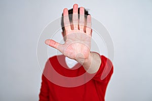 Mature man looking serious showing open palm making stop gesture