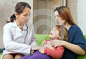 Mature children's doctor examining baby