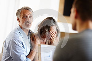 Mature couple, bad news or stress in home with surprise, crying or sad in meeting with financial advisor. Senior, man
