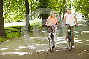 Mature couple on bikes outdoors