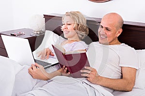 Mature couple burring with laptop