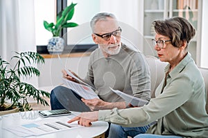 mature couple calculate expenses and planning monthly budget