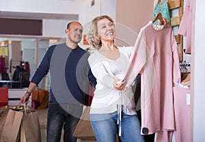 Mature couple choosing new apparel