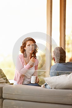 Mature couple, conversation and bonding with tea on a cabin porch, relationship and trust for discussion. Communication