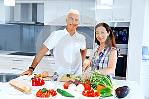 Mature couple cooking at home