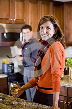 Mature couple cooking in kitchen at home